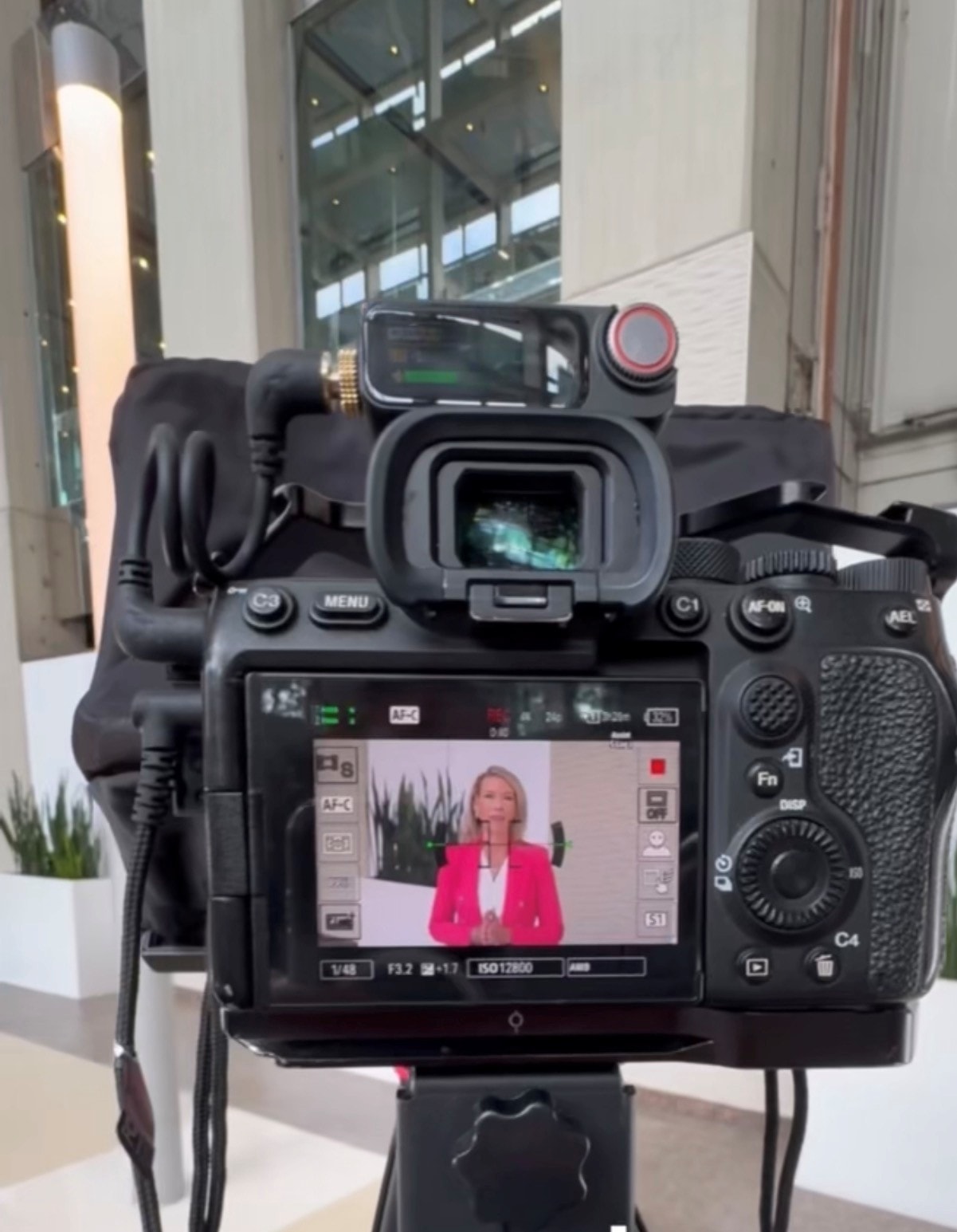 Meg Johnson being filmed on set for a speaking engagement